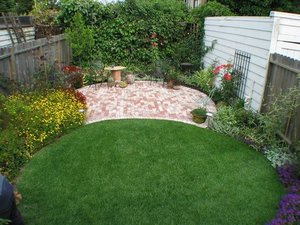 Brick Paver and Circular Lawn backyard